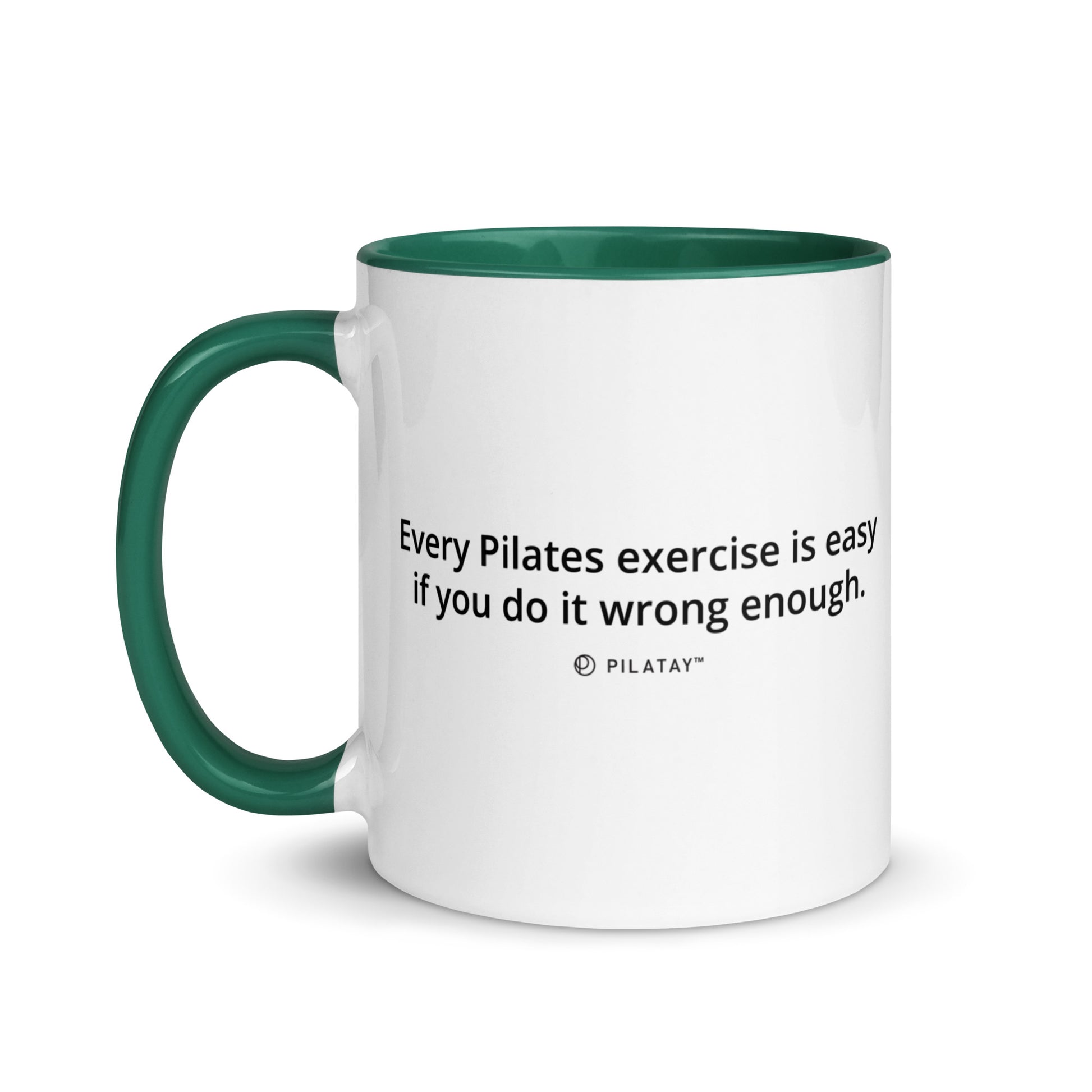 White mug with green handle and interior, featuring a Pilates quote.