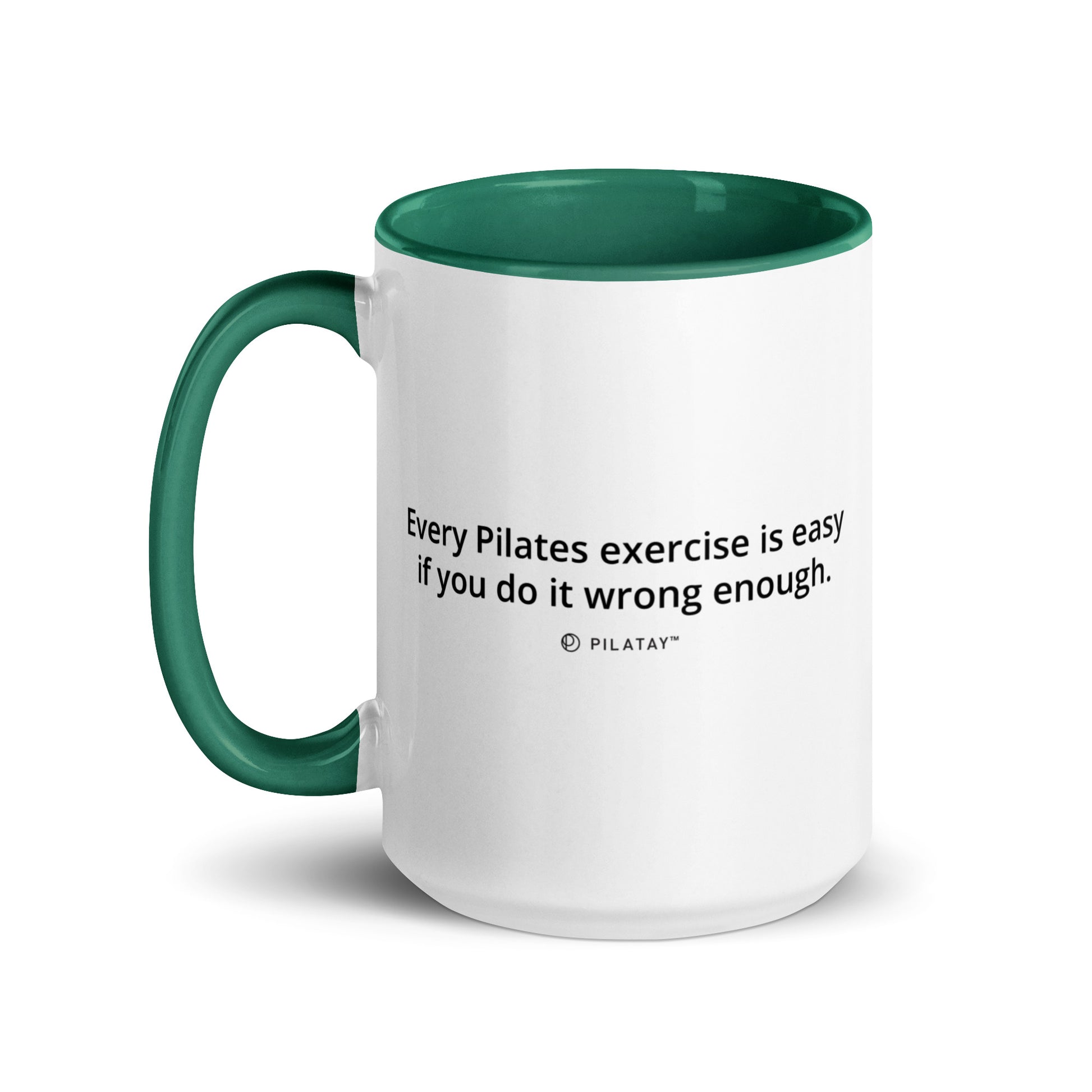 White mug with green interior and handle featuring a Pilates quote.