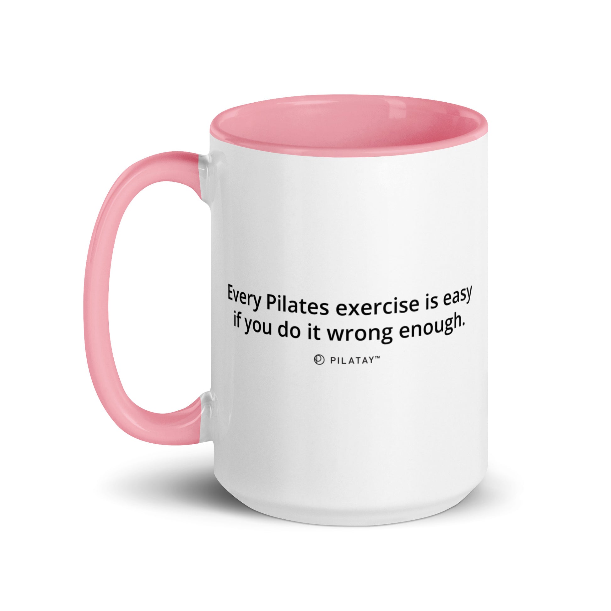 White mug with pink handle and interior, featuring a Pilates quote.